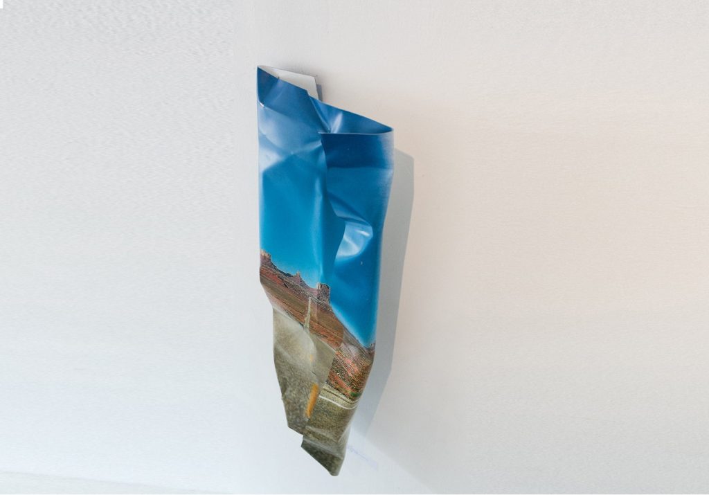 Crumpled photographic print of a desert road by Adam Turnbull from 'The City Is a Flower' at The Slow